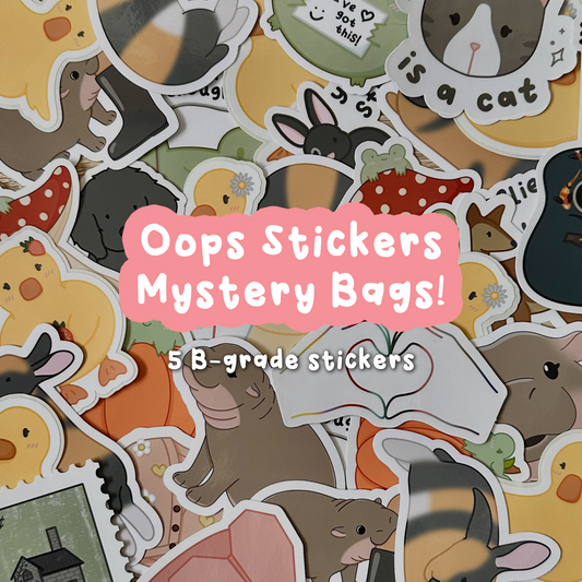 Various vinyl stickers laying out on a table. Designs include illustrated animals and several other themes.
Overtop is text that says "Oops Stickers Mystery Bags" and "5 B-grade stickers"