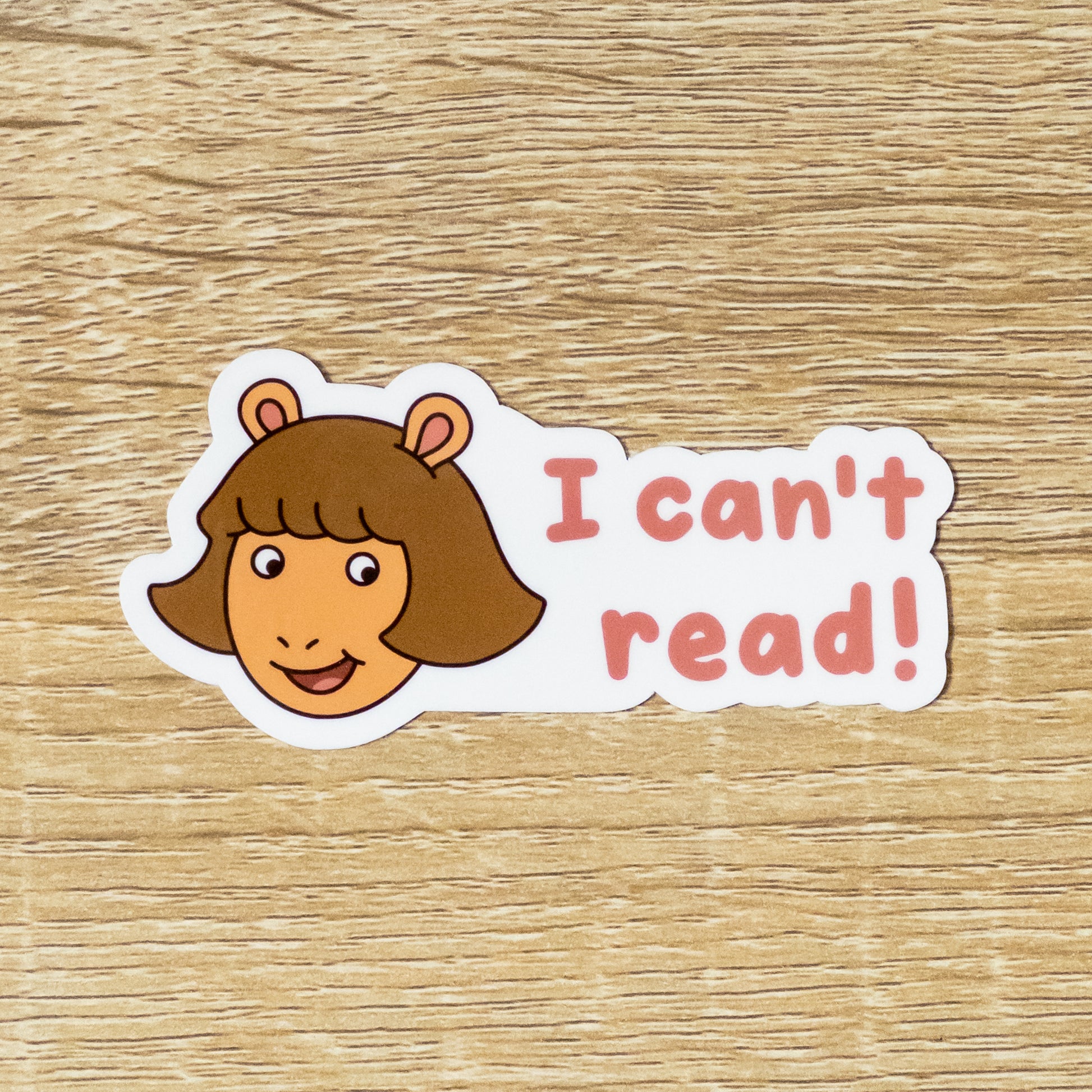 Glossy 3.5 inch wide sticker. Design is D.W. Read with the text, "I can't read!" Inspired by Athur the Aardvark from PBS Kids.