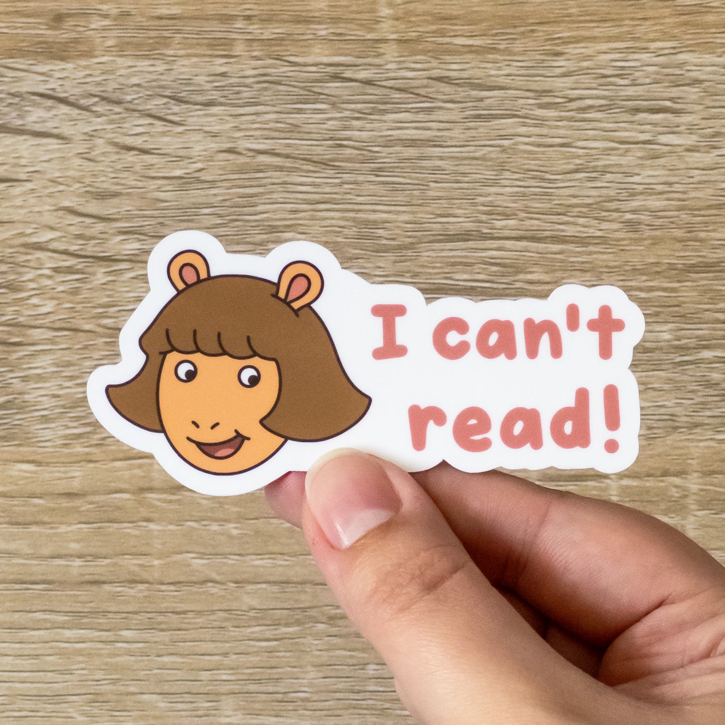 Glossy 3.5 inch wide sticker. Design is D.W. Read with the text, "I can't read!" Inspired by Athur the Aardvark from PBS Kids.