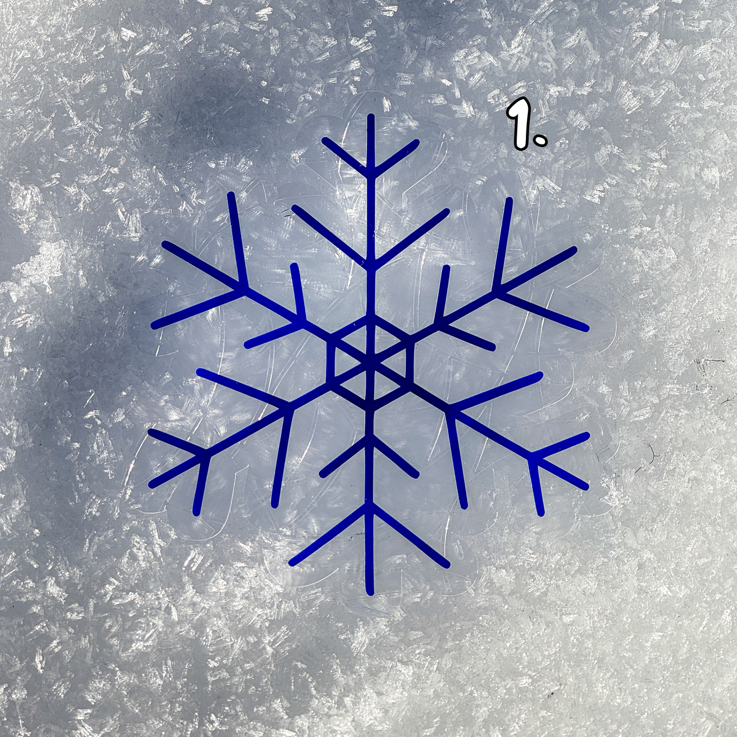 First design. Cozy winter snowflake suncatcher cling decal sticker.
The suncatcher has changed color to a deep blue. Resting on snow